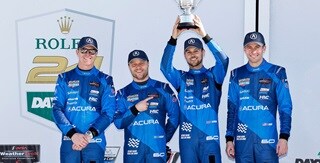 Acura drivers Scott Dixon, Felix Rosenqvist, Tom Blomqvist, and Colin Braun celebrate a second-place finish at the 2025 Rolex 24 at Daytona.