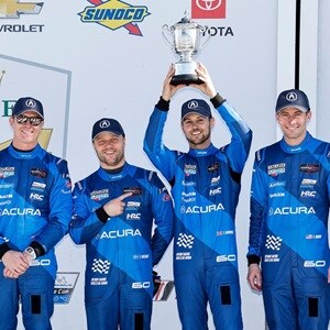 Acura drivers Scott Dixon, Felix Rosenqvist, Tom Blomqvist, and Colin Braun celebrate a second-place finish at the 2025 Rolex 24 at Daytona.