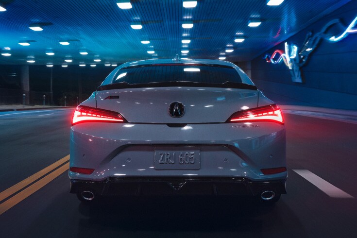 2026 Acura Integra A-Spec with Technology Package in Urban Gray Pearl, driving in a neon-lit tunnel (Premium Sport Compact).