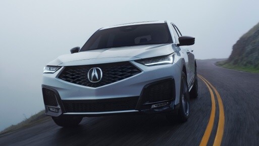 MDX front 3/4 action shot in Platinum White Pearl 
