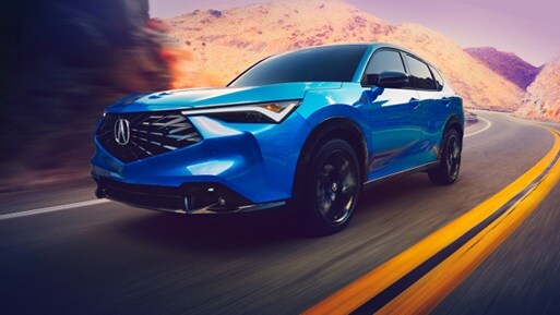 2026 Acura ADX A-Spec shown in Double Apex Blue Pearl II, driving on the road.