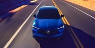 Acura 2025 ADX A-Spec with Advance Package in Adriatic Sea Blue Metallic front view on the road