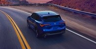 Acura 2025 ADX A-Spec with Advance Package in Adriatic Sea Blue Metallic rear view on the road
