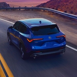 Acura 2025 ADX A-Spec with Advance Package in Adriatic Sea Blue Metallic rear view on the road