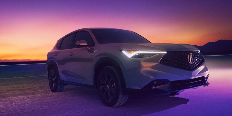 2026 Acura ADX A-Spec shown in Urban Gray Pearl, parked with a sunset in the background.