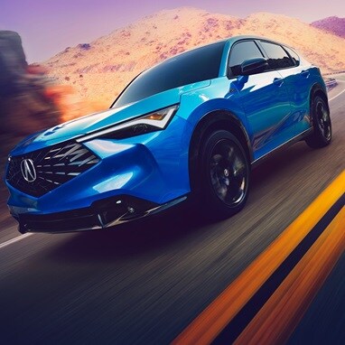 2026 Acura ADX A-Spec shown in Double Apex Blue Pearl II, driving on the road.