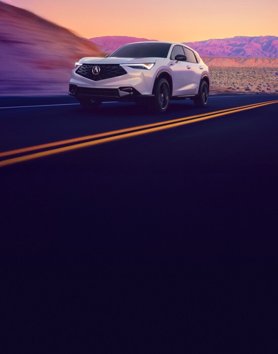 2026 Acura ADX A-Spec shown in Platinum White Pearl, driving on the road.