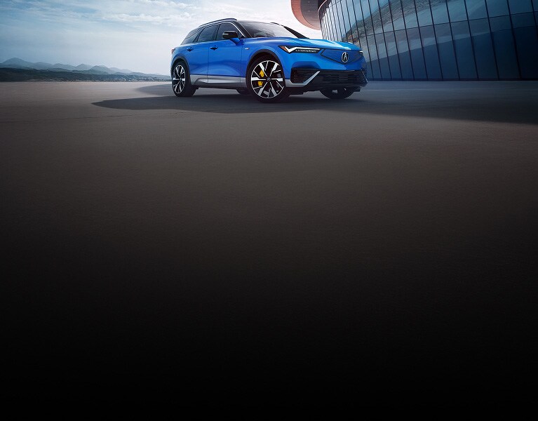 2024 Acura ZDX Type S in Double Apex Blue Pearl, parked in front of a modern building (Premium All-Electric SUV). 2024 Acura ZDX Type S in Double Apex Blue Pearl, parked in front of a modern building (Premium All-Electric SUV).