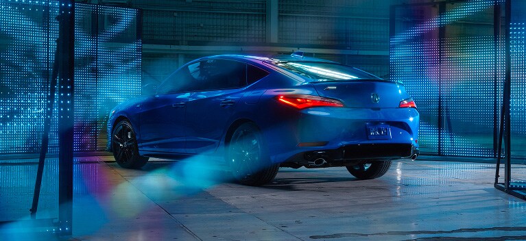2026 Acura Integra A-Spec with Technology Package shown in Double Apex Blue Pearl, parked inside a modern building.