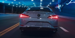 2026 Acura Integra in Urban Gray Pearl, rear view driving in a tunnel.
