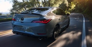 2026 Acura Integra car in Urban Gray Pearl driving on the road.