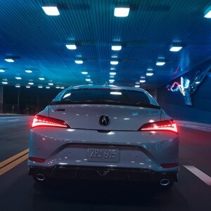 2026 Acura Integra in Urban Gray Pearl, rear view driving in a tunnel.