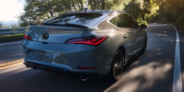 2026 Acura Integra car in Urban Gray Pearl driving on the road.