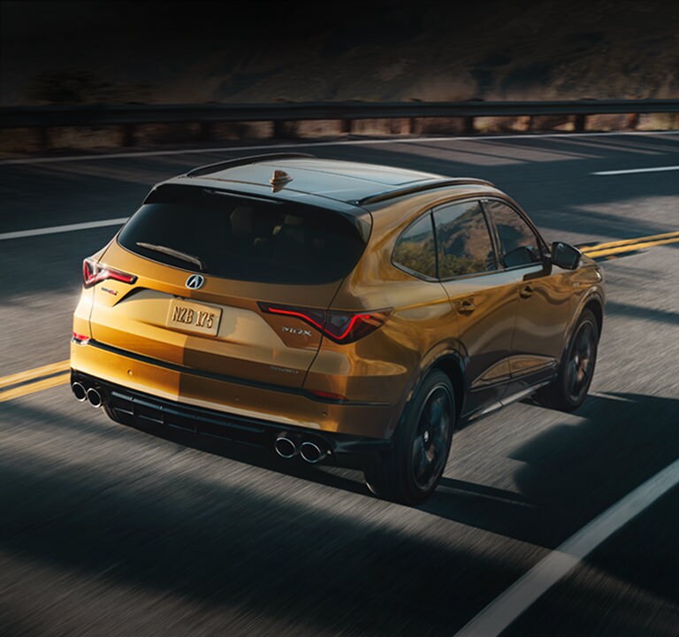 2022 Acura MDX Type S Advance Tiger Eye Pearl rear view in the street