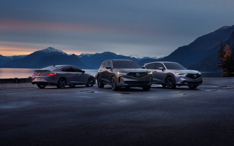 2026 Acura Integra, Acura MDX, and Acura ADX front and back parked by a mountain lake at dusk.