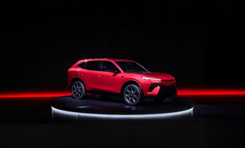 2026 Acura Hybrid 7/8 front on a dark studio stage with red lighting accents.